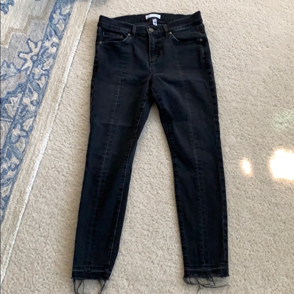 Black denim jeans with front seam detail.